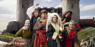 Welkom in de Middeleeuwen Een groepje in Middeleeuwse kleding uitgedoste acteurs voor een kasteel.